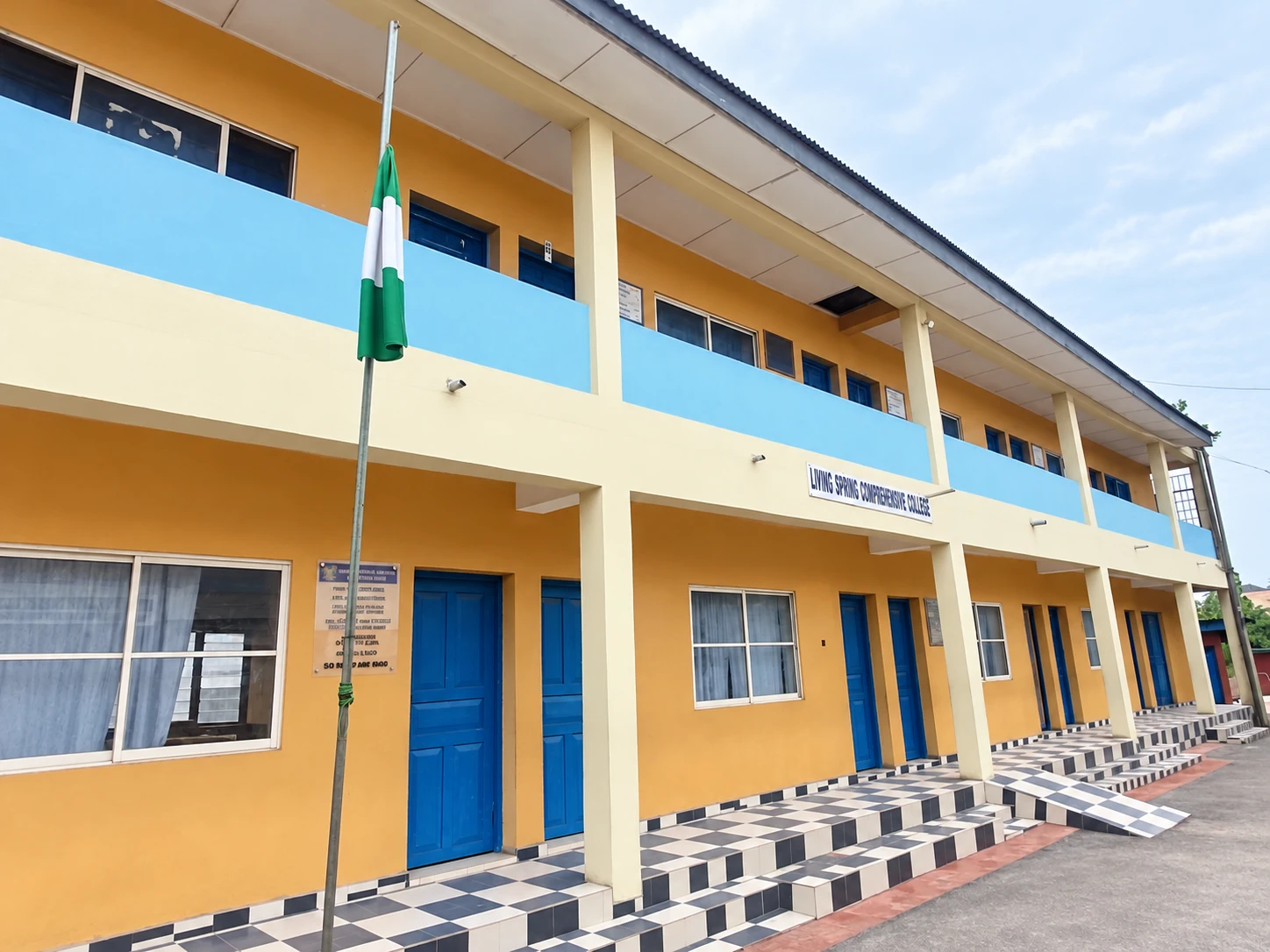 Living Spring Comprehensive College building and walkway with the Nigerian flag