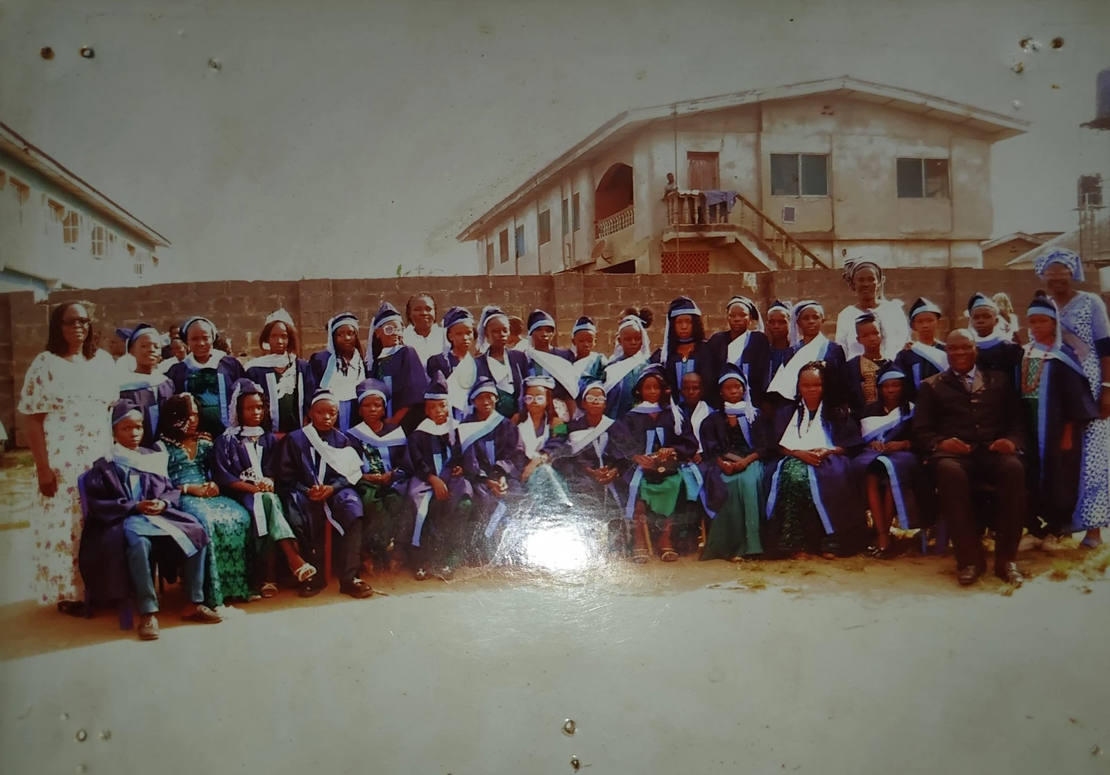 Graduates and adults in a group photograph from July 2025