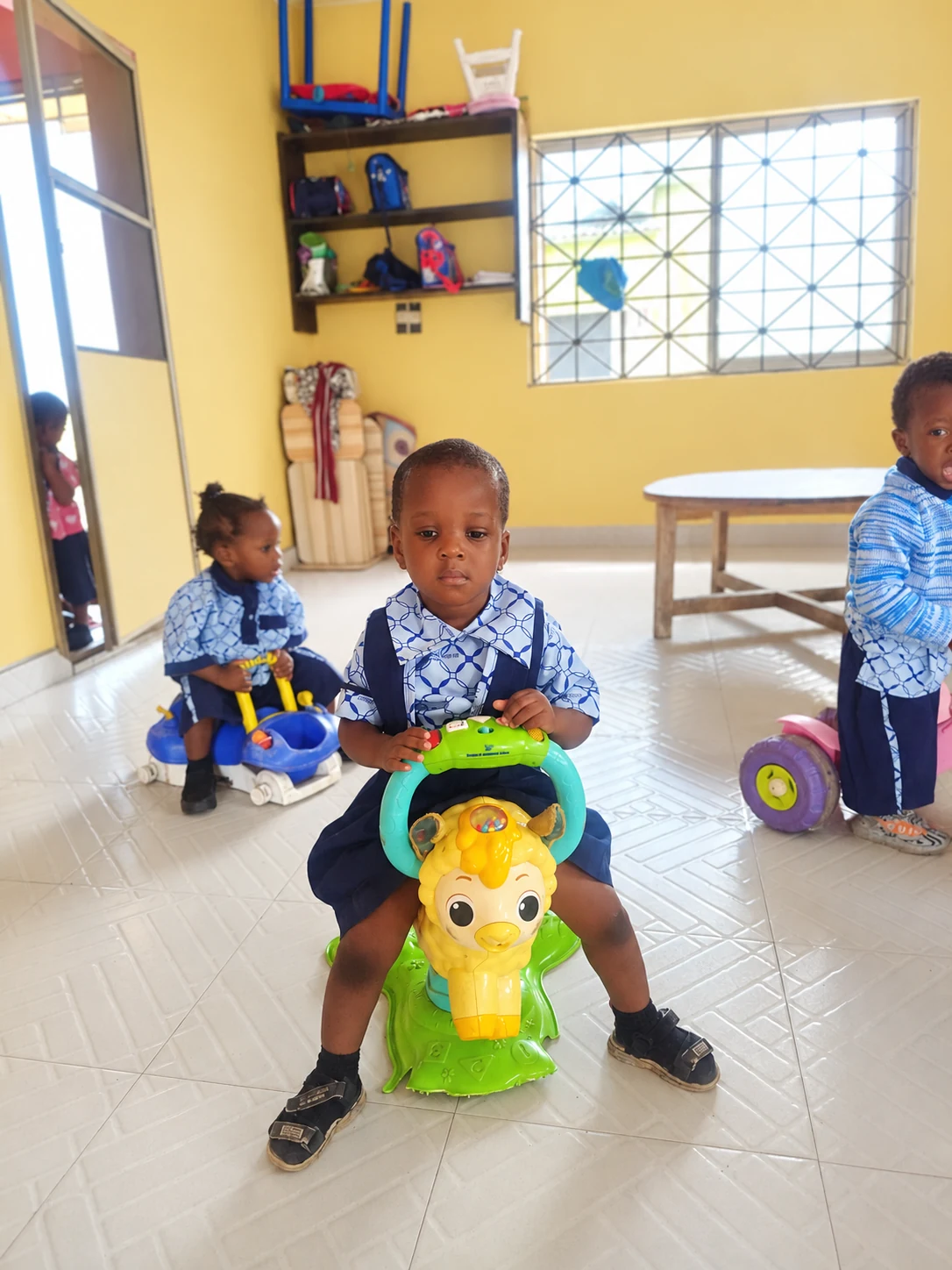 Early Years children exploring ride-on toys